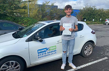 Driving student driving test success - Student test passed - Standing in front of driving school vehicle and displaying certificate