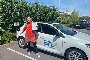 Student test passed - Standing in front of driving school vehicle and displaying certificate